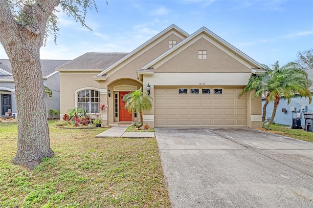 view of front of property with a garage and a front lawn