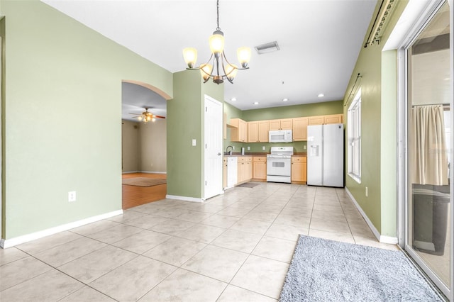 kitchen featuring pendant lighting, light tile patterned floors, white appliances, ceiling fan with notable chandelier, and light brown cabinets