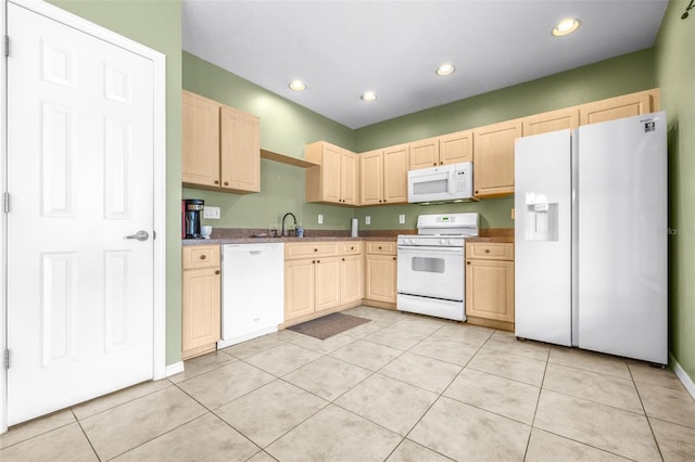 kitchen with sink, white appliances, light tile patterned flooring, and light brown cabinets