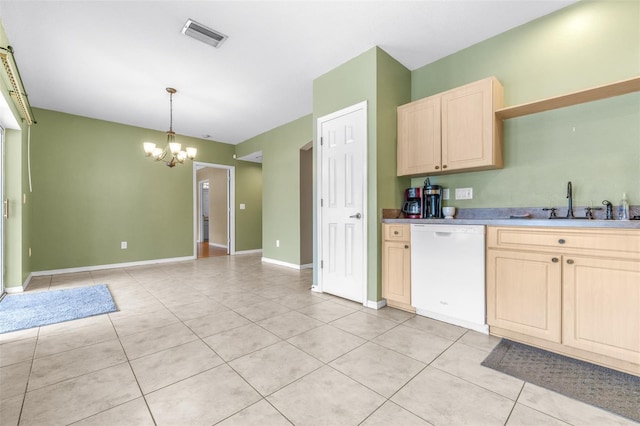 kitchen with pendant lighting, light brown cabinetry, dishwasher, and light tile patterned floors