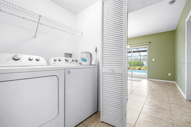 clothes washing area featuring light tile patterned floors and independent washer and dryer