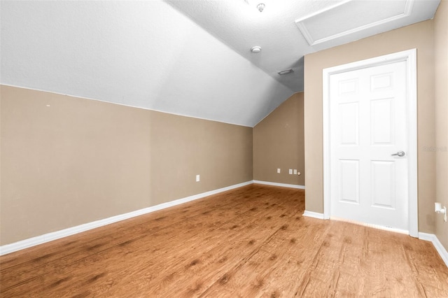 bonus room featuring vaulted ceiling and light hardwood / wood-style flooring