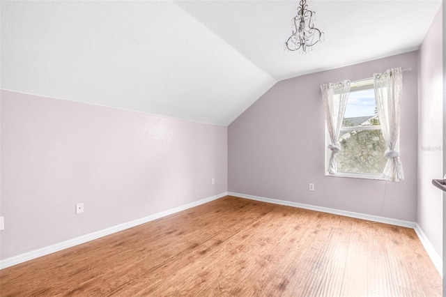 bonus room featuring lofted ceiling and wood-type flooring