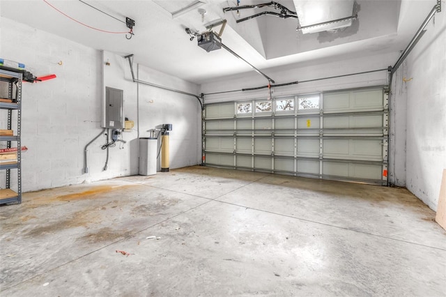 garage with a garage door opener and electric panel