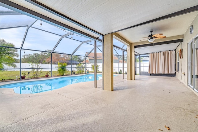 view of pool featuring a patio, ceiling fan, and glass enclosure