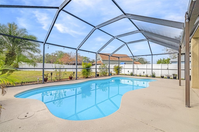 view of swimming pool featuring a lanai and a patio area