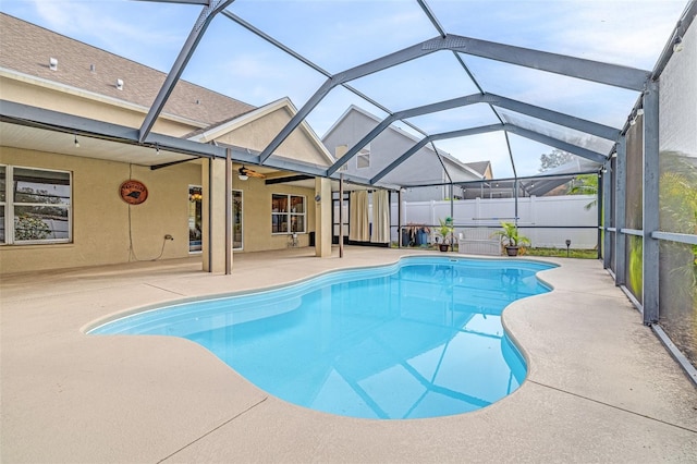 view of swimming pool featuring a patio area and glass enclosure