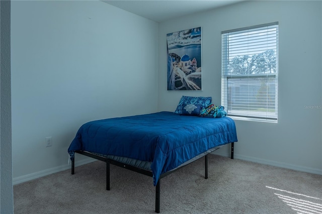 bedroom featuring light carpet