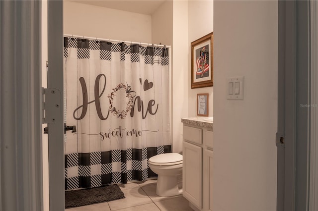 bathroom with a shower with curtain, vanity, toilet, and tile patterned flooring