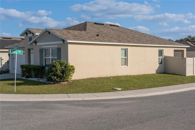 view of side of property with a yard