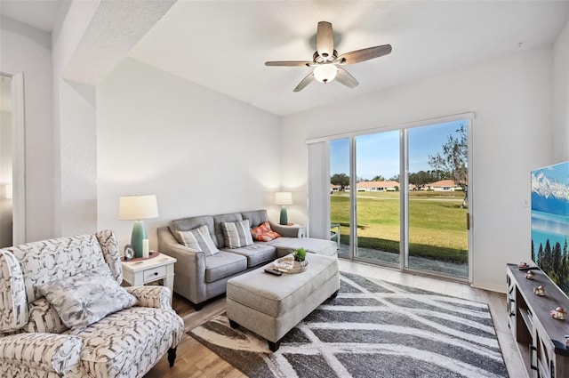 living room featuring hardwood / wood-style floors and ceiling fan