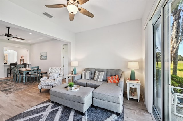 living room with hardwood / wood-style floors and ceiling fan