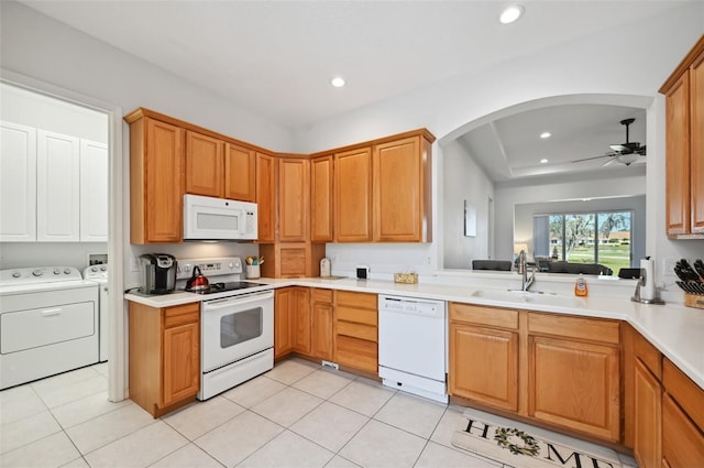 kitchen featuring light tile patterned flooring, separate washer and dryer, sink, ceiling fan, and white appliances