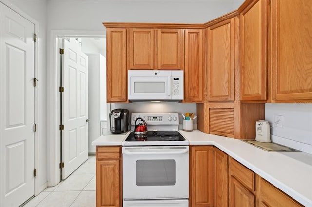 kitchen with white appliances and light tile patterned flooring