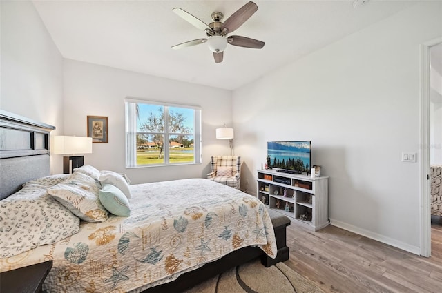 bedroom with ceiling fan and light hardwood / wood-style floors