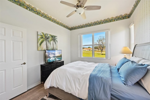 bedroom featuring ceiling fan and hardwood / wood-style floors