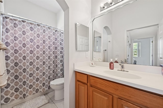 bathroom with a shower with curtain, vanity, tile patterned floors, and toilet