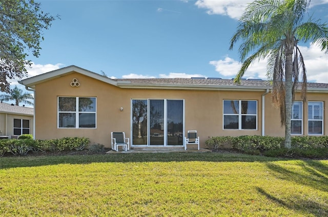 rear view of property with a yard