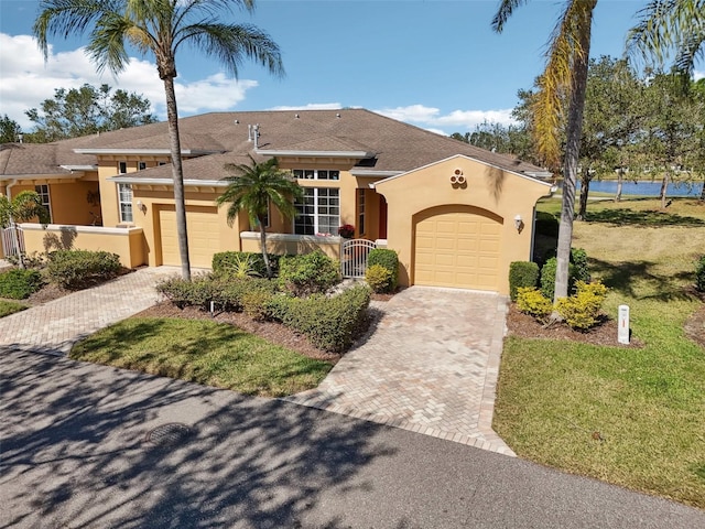 view of front of property featuring a garage and a front yard