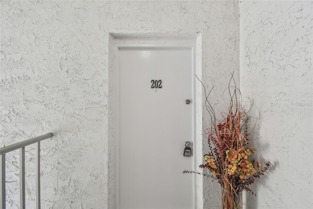 doorway to property with stucco siding