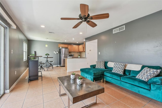 living area with light tile patterned floors, baseboards, visible vents, recessed lighting, and ceiling fan