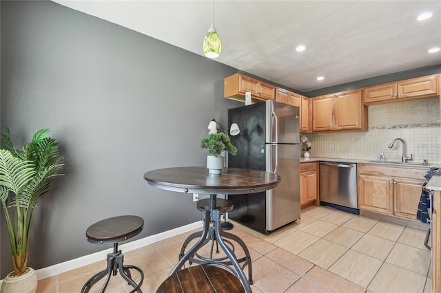 kitchen featuring tasteful backsplash, recessed lighting, appliances with stainless steel finishes, light tile patterned flooring, and a sink