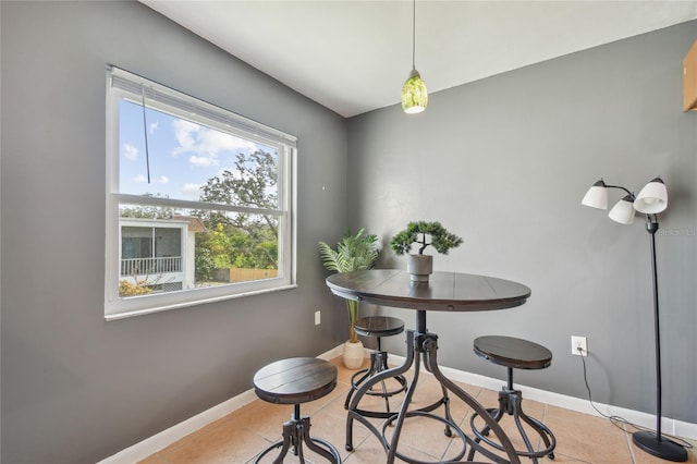 dining room with light tile patterned floors and baseboards