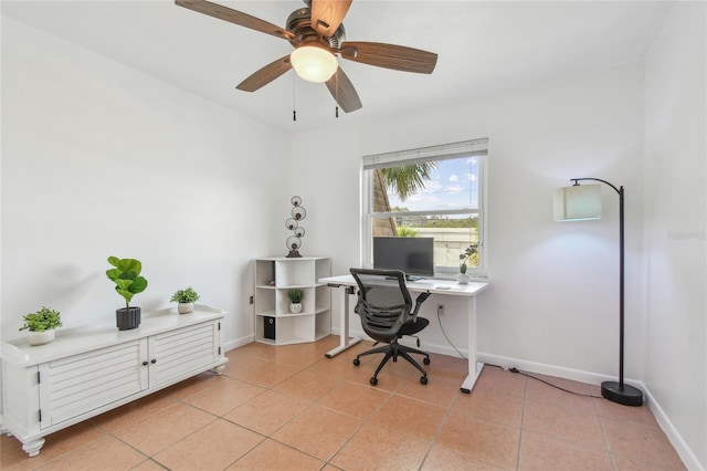 office featuring light tile patterned floors, baseboards, and ceiling fan