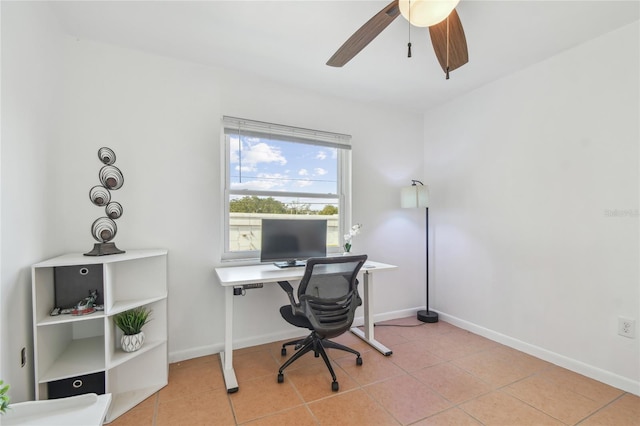 tiled home office featuring ceiling fan