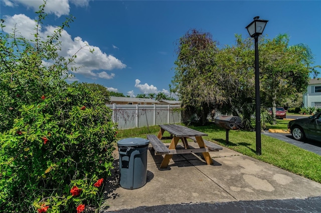 view of patio with outdoor dining space and fence