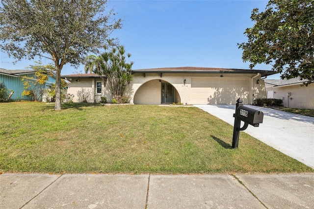 ranch-style home with a garage and a front yard