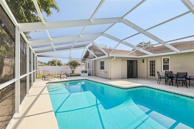 view of swimming pool with a patio and glass enclosure