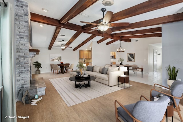 living room with lofted ceiling with beams, ceiling fan with notable chandelier, and light hardwood / wood-style flooring