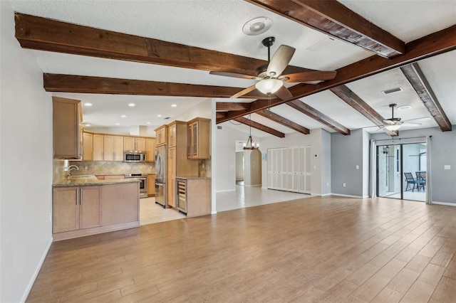 unfurnished living room with ceiling fan with notable chandelier, sink, light hardwood / wood-style flooring, and vaulted ceiling with beams