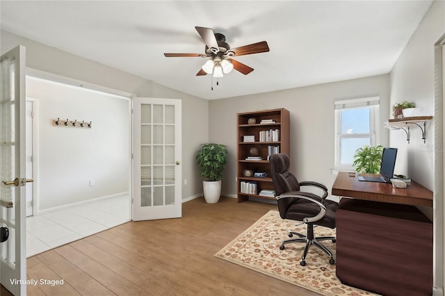 home office with french doors, ceiling fan, and light hardwood / wood-style flooring