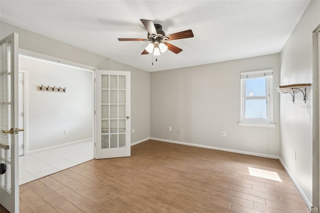 unfurnished room with french doors, ceiling fan, and light hardwood / wood-style floors