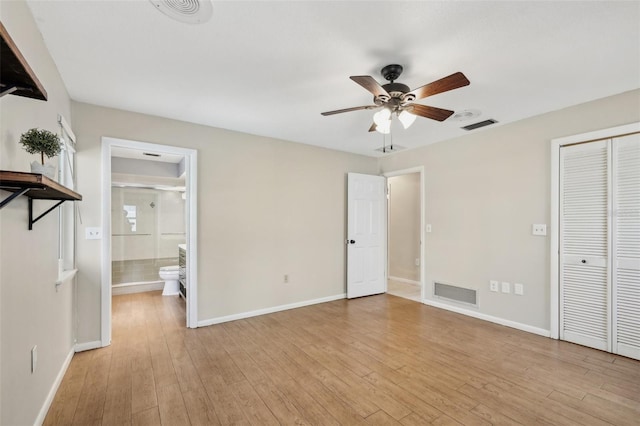 unfurnished bedroom featuring ensuite bath, light hardwood / wood-style floors, a closet, and ceiling fan