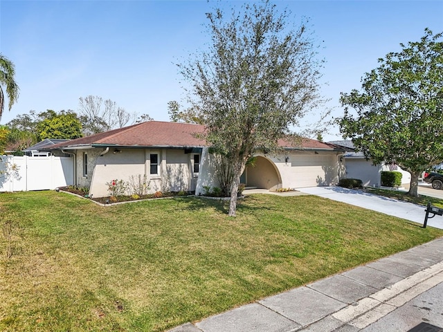 ranch-style home featuring a garage and a front lawn