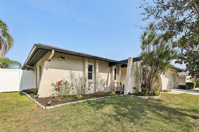 ranch-style home featuring a garage and a front lawn