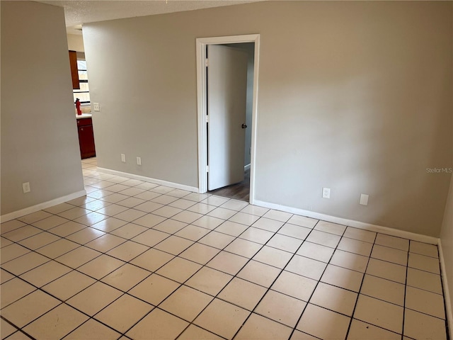 unfurnished room with light tile patterned floors