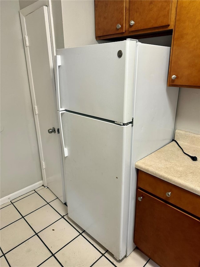 kitchen featuring light tile patterned flooring and white fridge