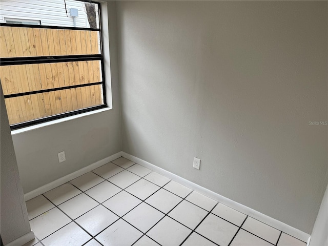 unfurnished room with light tile patterned floors