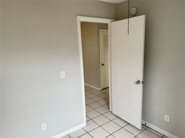 unfurnished bedroom with light tile patterned floors