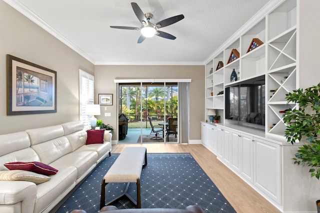 living room with ornamental molding, ceiling fan, and light hardwood / wood-style flooring