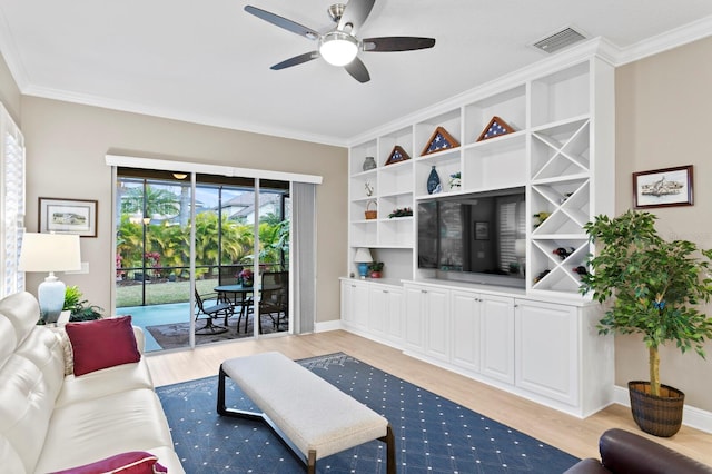 living room with crown molding, ceiling fan, and light hardwood / wood-style flooring