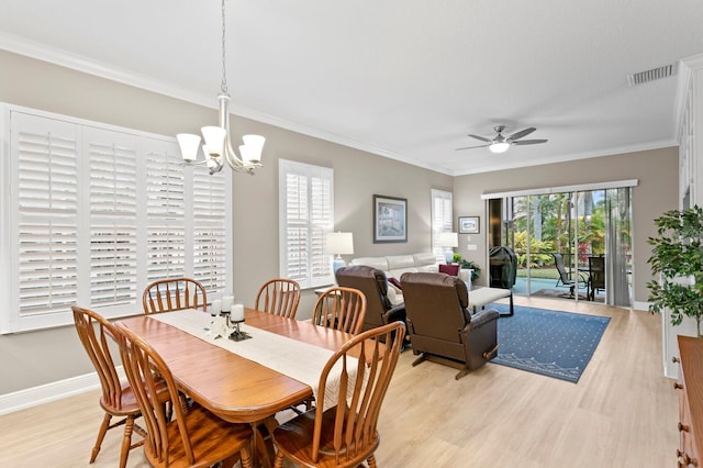 dining area featuring ornamental molding, ceiling fan with notable chandelier, and light hardwood / wood-style flooring