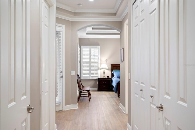 hall featuring crown molding and light hardwood / wood-style floors