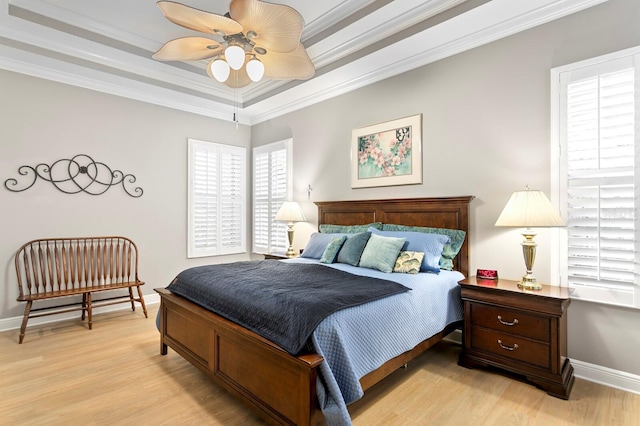 bedroom with crown molding, ceiling fan, and light hardwood / wood-style flooring