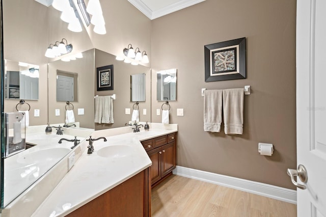 bathroom with vanity, hardwood / wood-style flooring, and ornamental molding