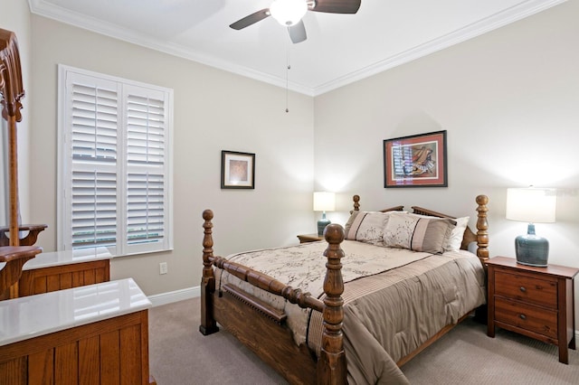 carpeted bedroom with ornamental molding and ceiling fan